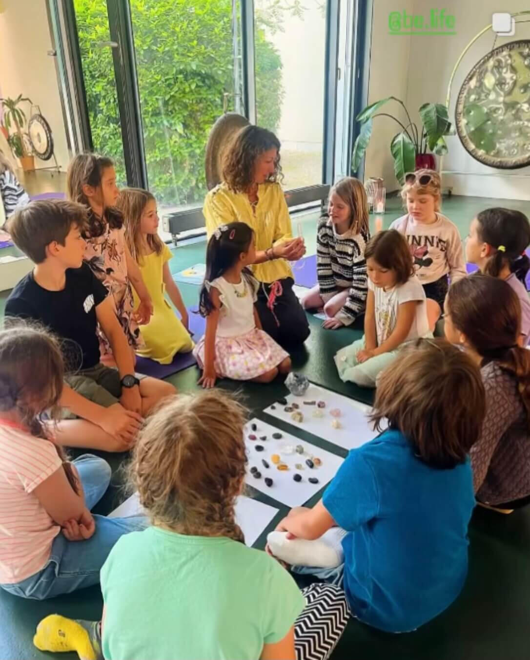 This is a photo of Teodora of London Rock Club teaching children about crystals.