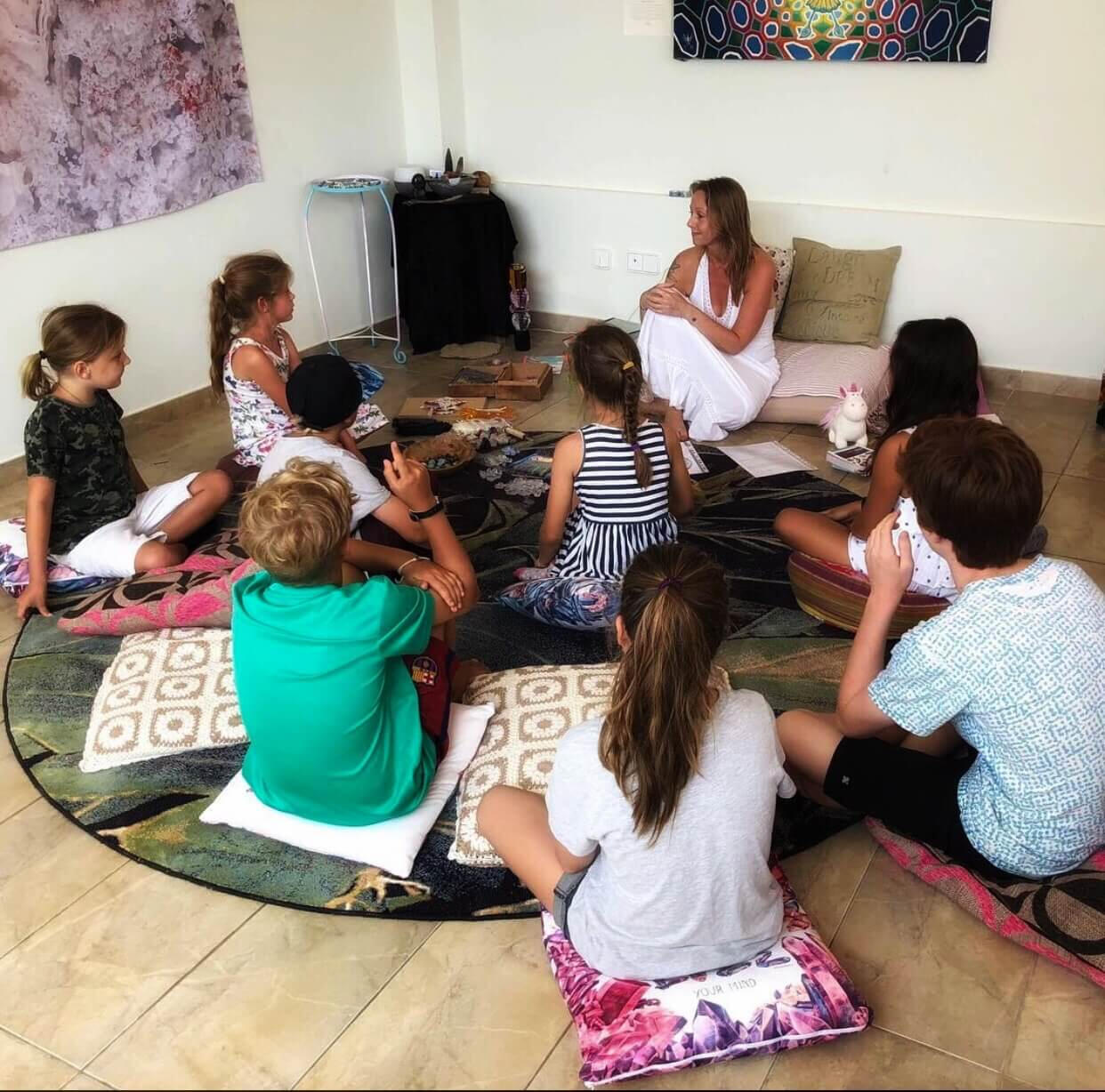 This is a photo of Jade Marsh teaching children about crystals in Ibiza Rock Club.